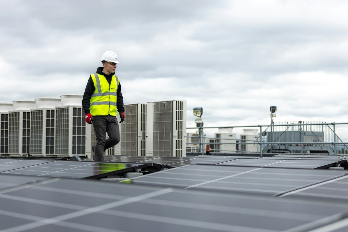 Technician working on a commercial rooftop HVAC unit
