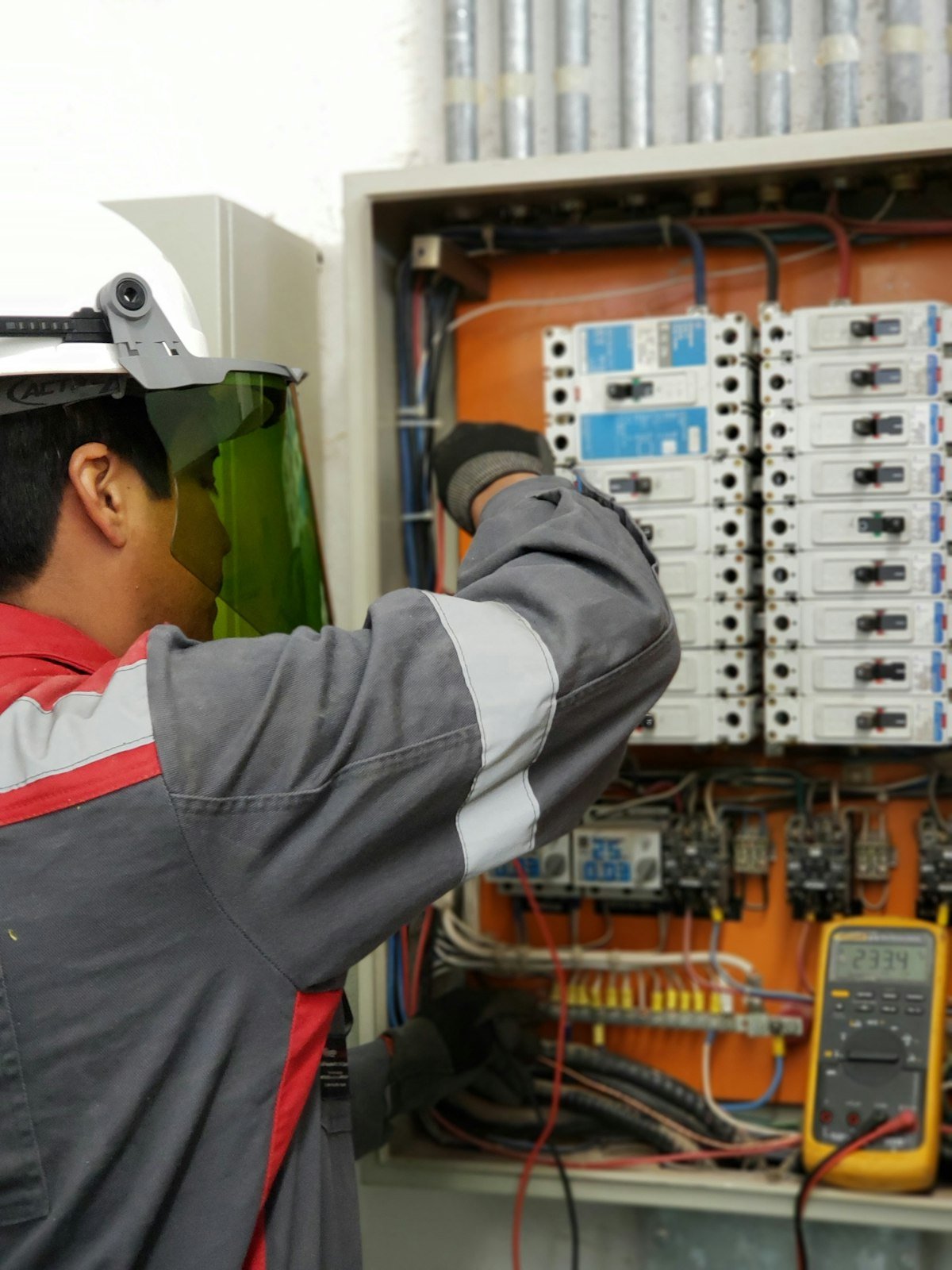 Technician in protective gear performing an urgent HVAC system check