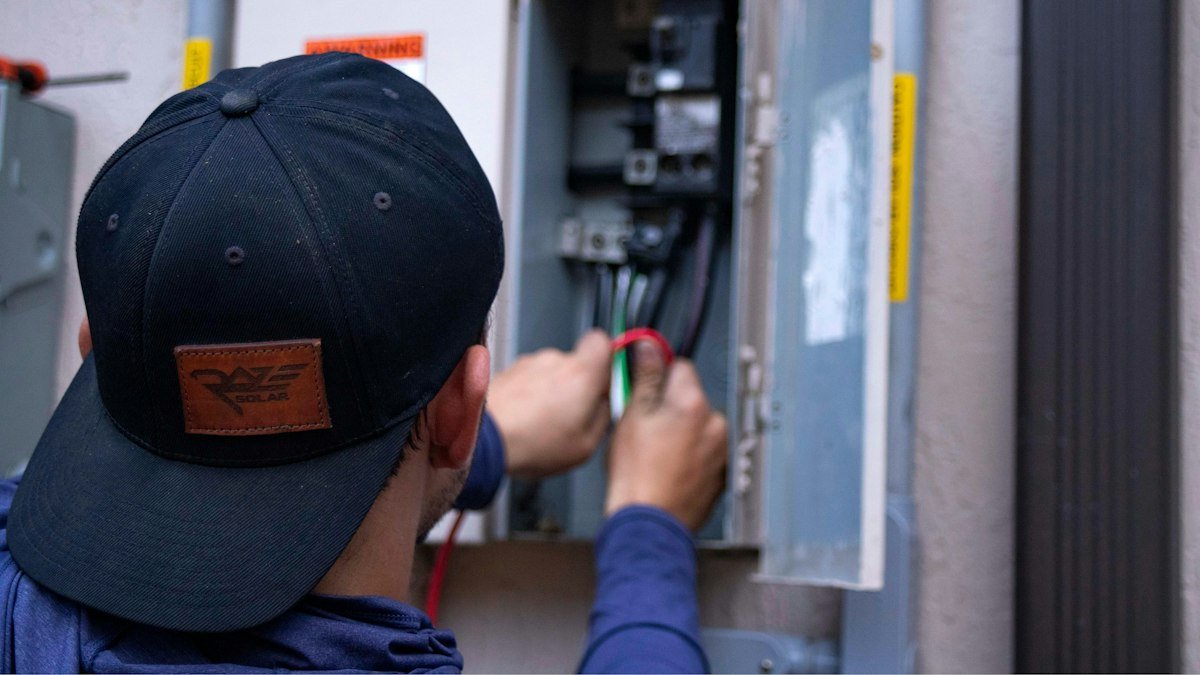 Technician servicing a heating system component